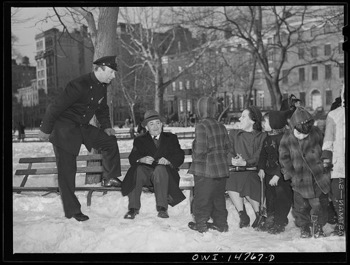 New York, New York. An Italian-American cop chatting with a group of Italian-Americans in Washington Square Park