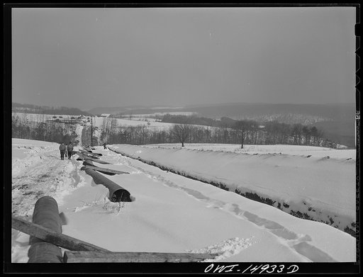 Pennsylvania section of the war emergency twenty-four inch pipeline to carry oil from Texas fields to eastern refineries, completed in July 1943. Ditch and strung pipe running through the Amish country of Lancashire County