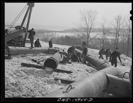 Pennsylvania section of the war emergency twenty-four inch pipeline to carry oil from Texas fields to eastern refineries, completed in July 1943. Making a bend in a section of pipe