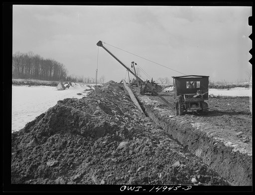 Pennsylvania section of the war emergency twenty-four inch pipeline to carry oil from Texas fields to eastern refineries, completed in July 1943. Backfilling the ditch after the pipe has been laid