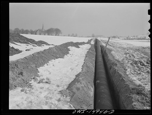 Pennsylvania section of the war emergency twenty-four inch pipeline to carry oil from Texas fields to eastern refineries, completed in July 1943. Pipe laid in the ditch, ready to be covered over
