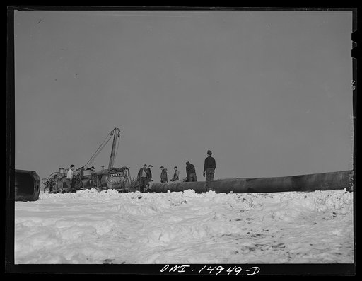 Pennsylvania section of the war emergency twenty-four inch pipeline to carry oil from Texas fields to eastern refineries, completed in July 1943. Preparing to hoist a section of pipe