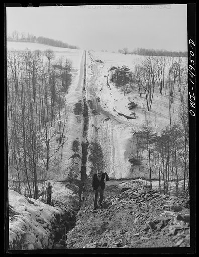 Pennsylvania section of the war emergency twenty-four inch pipeline to carry oil from Texas fields to eastern refineries, completed in July 1943. Six-foot ditch through hilly country