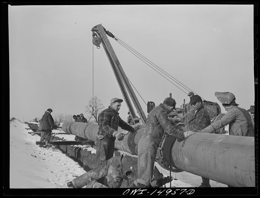 Pennsylvania section of the war emergency twenty-four inch pipeline to carry oil from Texas fields to eastern refineries, completed in July 1943. Joining together two forty-foot sections of pipe by the stove-pipe method of welding