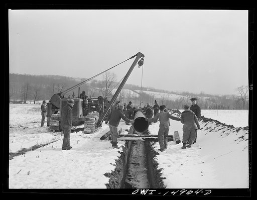 Pennsylvania section of the war emergency twenty-four inch pipeline to carry oil from Texas fields to eastern refineries, completed in July 1943. Joining a section of pipe to the line