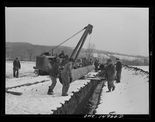 Pennsylvania section of the war emergency twenty-four inch pipeline to carry oil from Texas fields to eastern refineries, completed in July 1943. Joining a section of pipe to the line
