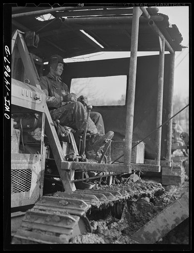 Pennsylvania section of the war emergency twenty-four inch pipeline to carry oil from Texas fields to eastern refineries, completed in July 1943. The operator of the ditching machine