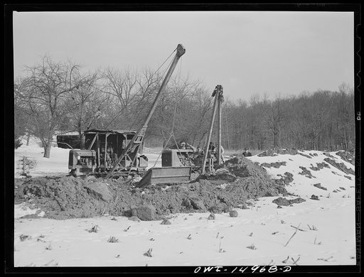 Pennsylvania section of the war emergency twenty-four inch pipeline to carry oil from Texas fields to eastern refineries, completed in July 1943. Backfilling the ditch after the pipe has been laid