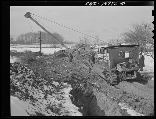 Pennsylvania section of the war emergency twenty-four inch pipeline to carry oil from Texas fields to eastern refineries, completed in July 1943. Backfilling the ditch after the pipe has been laid