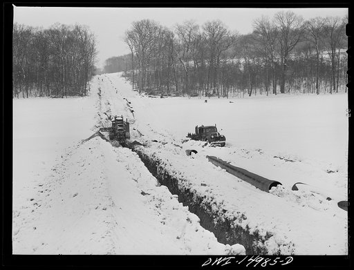 Pennsylvania section of the war emergency twenty-four inch pipeline to carry oil from Texas fields to eastern refineries, completed in July 1943. Ditching machine going through the right of way. This machine digs a six-foot trench