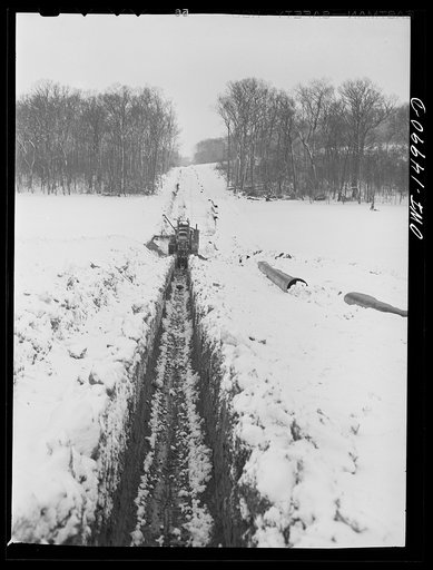 Pennsylvania section of the war emergency twenty-four inch pipeline to carry oil from Texas fields to eastern refineries, completed in July 1943. Ditching machine going through the right of way. This machine digs a six-foot trench