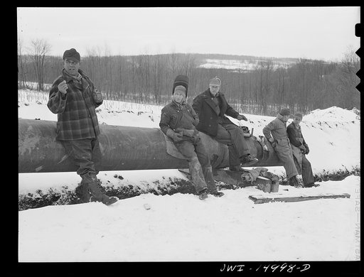 Pennsylvania section of the war emergency twenty-four inch pipeline to carry oil from Texas fields to eastern refineries, completed in July 1943. Members of the laying-in gang