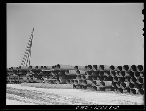 Pennsylvania section of the war emergency twenty-four inch pipeline to carry oil from Texas fields to eastern refineries, completed in July 1943. Pipe stacked along the railroad tracks