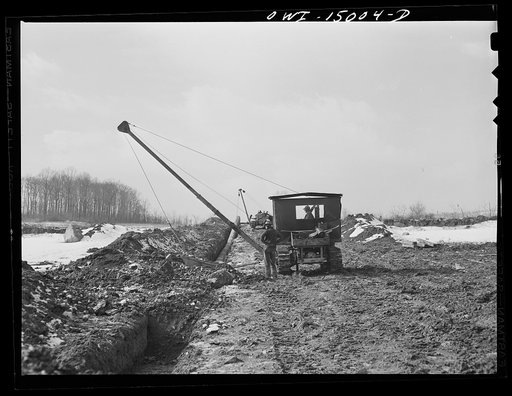 Pennsylvania section of the war emergency twenty-four inch pipeline to carry oil from Texas fields to eastern refineries, completed in July 1943. Backfilling the ditch after the pipe has been laid