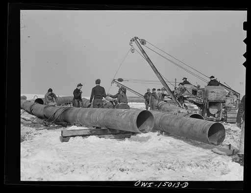 Pennsylvania section of the war emergency twenty-four inch pipeline to carry oil from Texas fields to eastern refineries, completed in July 1943. Making a bend in a section of pipe
