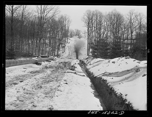 Pennsylvania section of the war emergency twenty-four inch pipeline to carry oil from Texas fields to eastern refineries, completed in July 1943. Blasting hard rock through which ditching machine could not penetrate
