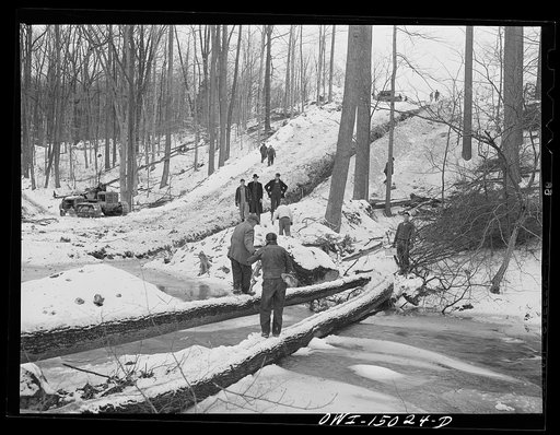 Pennsylvania section of the war emergency twenty-four inch pipeline to carry oil from Texas fields to eastern refineries, completed in July, 1943. Pipeline workers crossing a stream