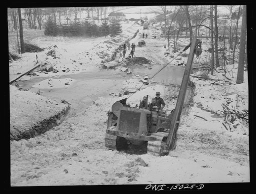 Pennsylvania section of the war emergency twenty-four inch pipeline to carry oil from Texas fields to eastern refineries, completed in July, 1943. Caterpillar tractor climbing a hill