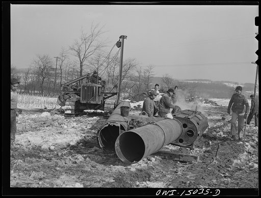 Pennsylvania section of the war emergency twenty-four inch pipeline to carry oil from Texas fields to eastern refineries, completed in July, 1943. Making a bend in a section of pipe
