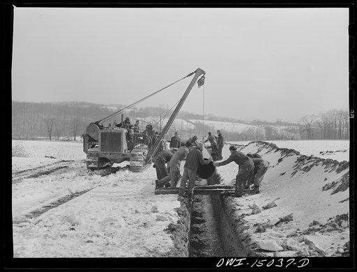 Pennsylvania section of the war emergency twenty-four inch pipeline to carry oil from Texas fields to eastern refineries, completed in July, 1943. Joining a section of pipe to the main line