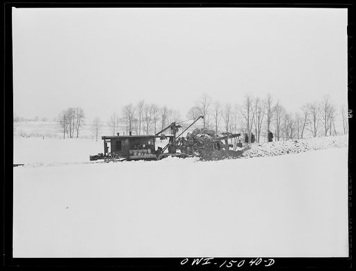 Pennsylvania section of the war emergency twenty-four inch pipeline to carry oil from Texas fields to eastern refineries, completed in July, 1943. Ditching machine going through the woods