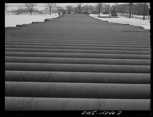 Pennsylvania section of the war emergency twenty-four inch pipeline to carry oil from Texas fields to eastern refineries, completed in July, 1943. Pipe stred along the railroad tracks