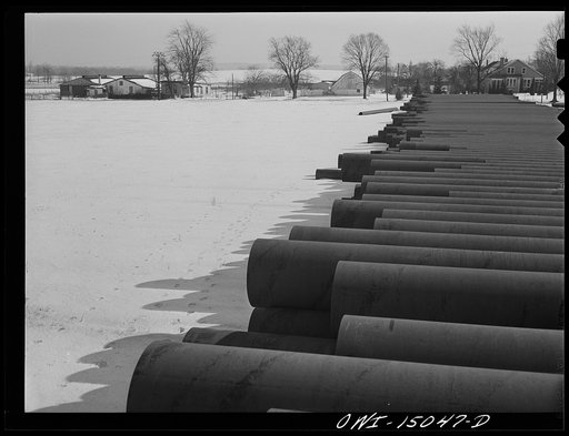 Pennsylvania section of the war emergency twenty-four inch pipeline to carry oil from Texas fields to eastern refineries, completed in July, 1943. Pipe stred along the railroad tracks