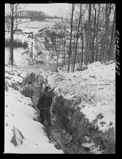 Pennsylvania section of the war emergency twenty-four inch pipeline to carry oil from Texas fields to eastern refineries, completed in July, 1943. Clearing rock out of the ditch