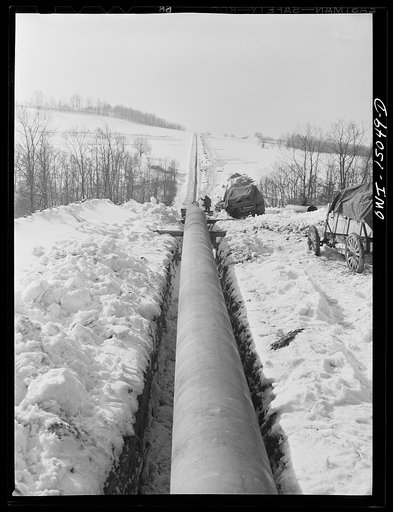 Pennsylvania section of the war emergency twenty-four inch pipeline to carry oil from Texas fields to eastern refineries, completed in July, 1943. Pipeline going through a hilly section