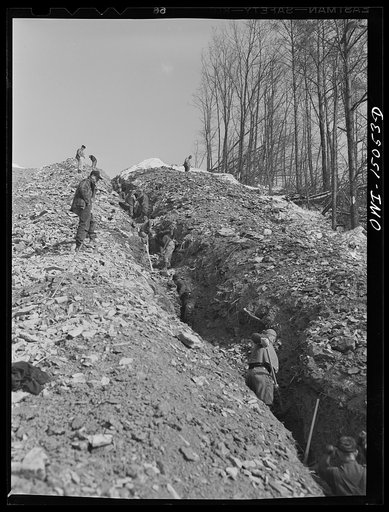 Pennsylvania section of the war emergency twenty-four inch pipeline to carry oil from Texas fields to eastern refineries, completed in July, 1943. Clearing rock out of the ditch