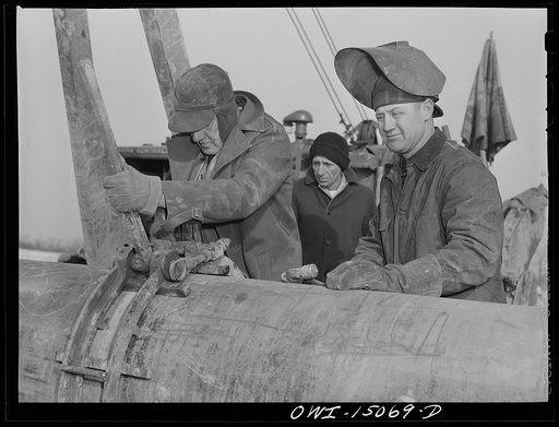 Pennsylvania section of the war emergency twenty-four inch pipeline to carry oil from Texas fields to eastern refineries, completed in July, 1943. Joining a forty-foot section of pipe to the main line