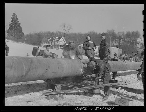 Pennsylvania section of the war emergency twenty-four inch pipeline to carry oil from Texas fields to eastern refineries, completed in July, 1943. Welding together forty-foot section of pipe