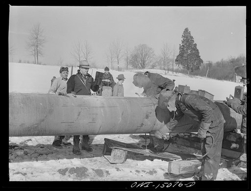 Pennsylvania section of the war emergency twenty-four inch pipeline to carry oil from Texas fields to eastern refineries, completed in July, 1943. Welding together forty-foot section of pipe