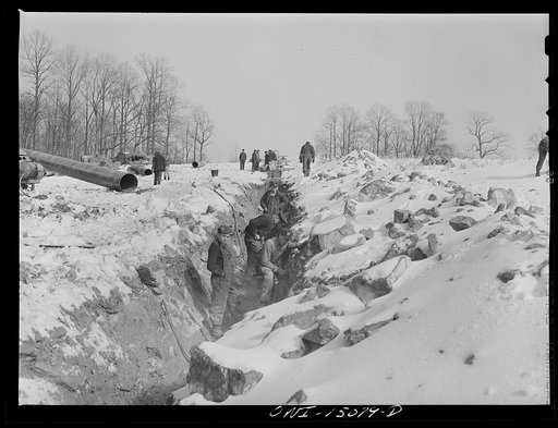 Pennsylvania section of the war emergency twenty-four inch pipeline to carry oil from Texas fields to eastern refineries, completed in July, 1943. Gang clearing rocks out of the ditch