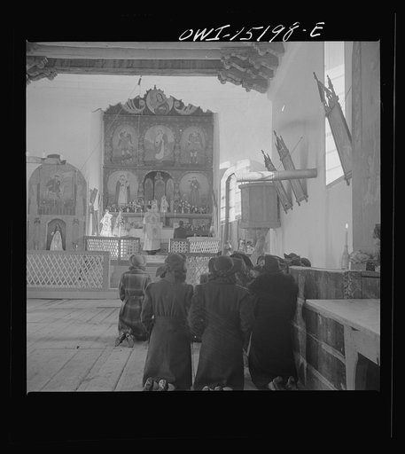 Untitled photo, possibly related to: Trampas, New Mexico. Father Cassidy conducting mass at a church which was built in 1700 and is the best-preserved colonial mission in the Southwest
