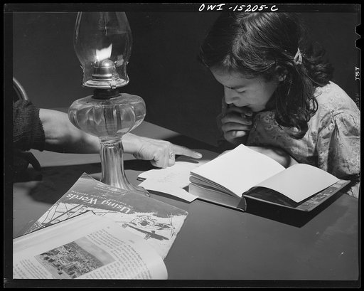 Trampas, New Mexico. Mrs. Maclovia Lopez, can read and write English well; she also keeps the family books in the evenings and helps the children with their homework