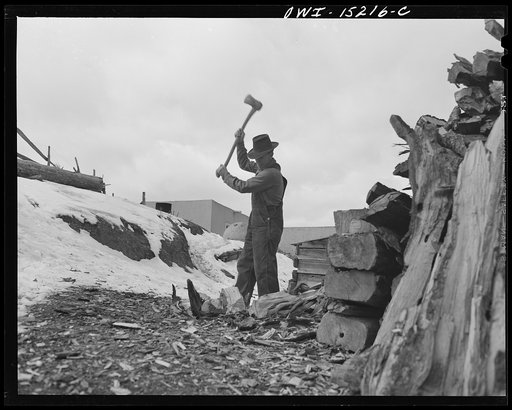 Trampas, New Mexico. Juan Lopez, the majordomo (mayor) [i.e., steward], cutting and splitting wood for the fireplace and the cook stove