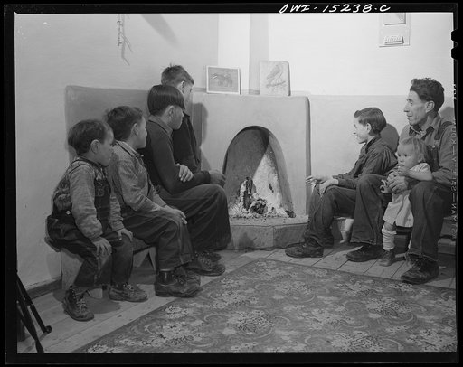 Trampas, New Mexico. The corner fireplace, like this one in the home of Juan Lopez, the majordomo (mayor) [i.e., steward], is the most efficient fireplace. It burns little wood and all the heat circulates out along the walls, so that there is no "cold spot" as with English fireplaces
