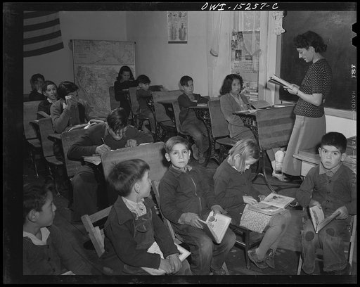 Untitled photo, possibly related to: Trampas, New Mexico. Grade school teacher ringing a bell to call her class