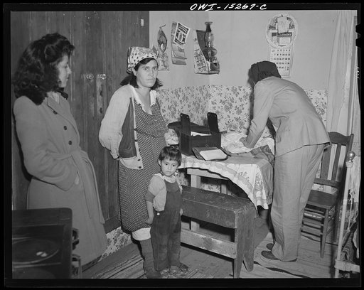 Llano Quemado (vicinity), New Mexico. Marjorie Muller, nurse from the clinic operated by the Taos County cooperative health association, making a home call