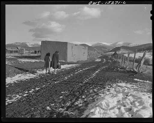Llano Quemado (vicinity), New Mexico. Marjorie Muller, nurse from the clinic operated by the Taos County cooperative health association, and an interpreter leaving the ambulance to reach a patient's house, beyond passable roads