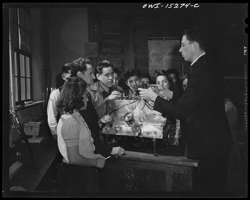 Taos County, New Mexico. Father Cassidy, the Catholic priest of the Parish of Penasco, teaching a general science class in the high school