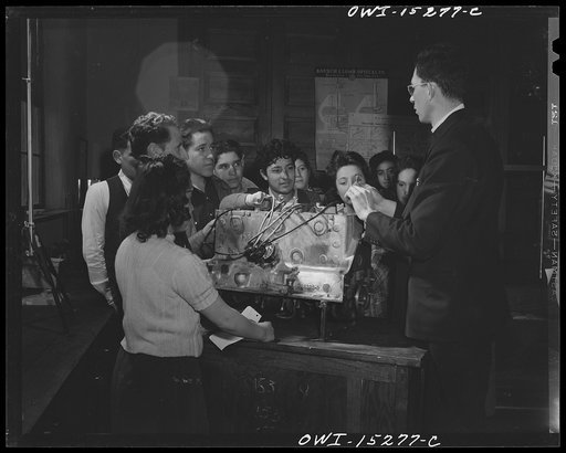 Untitled photo, possibly related to: Taos County, New Mexico. Father Cassidy, the Catholic priest of the Parish of Penasco, teaching a general science class in the high school