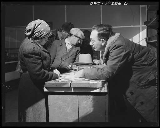 Chacon, Mora County, New Mexico. United States forest ranger in the general store issuing grazing permits to Spanish-American ranchers
