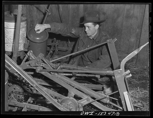 Untitled photo, possibly related to: Rio Grande, Ohio. Wayne Gibson examining corn planter at Rio Grande College. He formerly farmed with his father in Jackson County, Kentucky