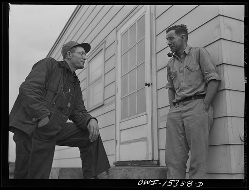 Rio Grande, Gallia County, Ohio. Mr. Younkers talking with his boss, Fred Bowers, poultry farmer. Mr. Younkers, his wife and three sons have come up from Kentucky