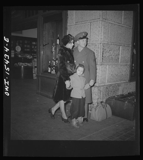 Untitled photo, possibly related to: Chicago, Illinois. Soldier and his family waiting for a train at the Union Station
