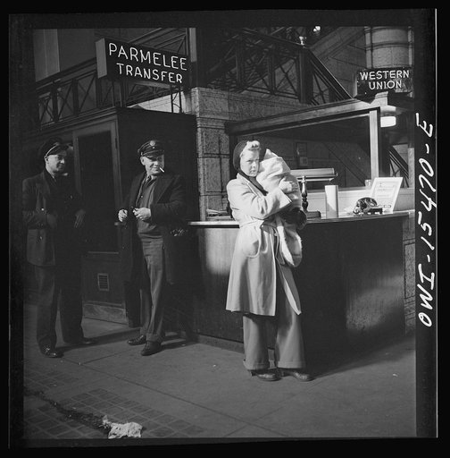 Chicago, Illinois. Waiting for a train in the concourse of the Union Station. Parmelee transfer sign
