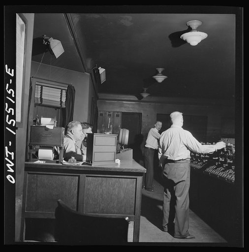 Untitled photo, possibly related to: Chicago, Illinois. In the interlocking tower at Union Station. It is here that all inbound and outbound traffic is controlled. The men work entirely by the board, hardly ever looking out of a window to see an actual train