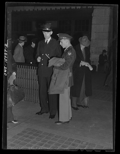 Chicago, Illinois. Train master giving advice to a young officer at the Union Station